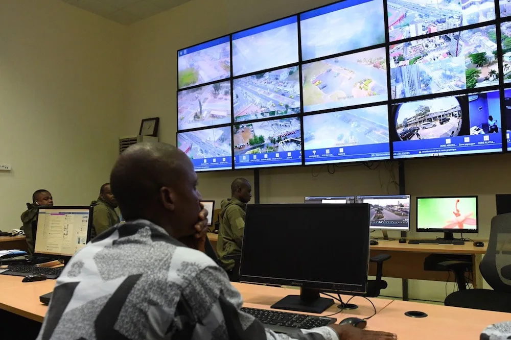 Operators monitoring a wall of live surveillance feeds